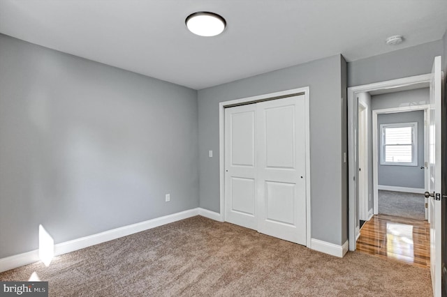 unfurnished bedroom with carpet floors and a closet