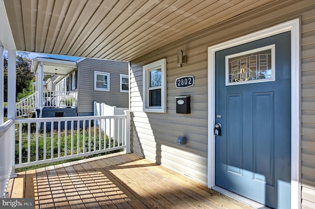 view of exterior entry with a porch