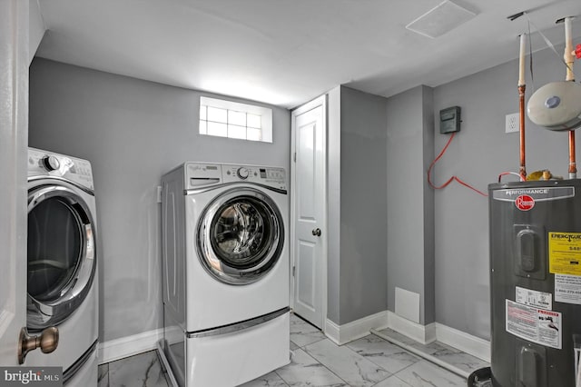 washroom featuring electric water heater and separate washer and dryer