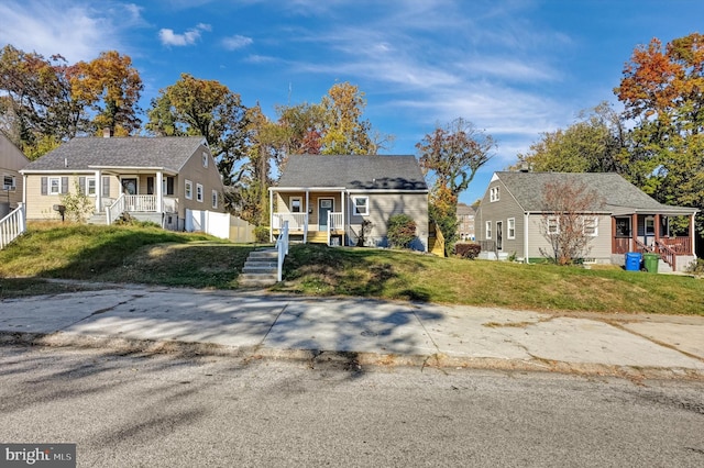 view of front of home with a porch and a front lawn