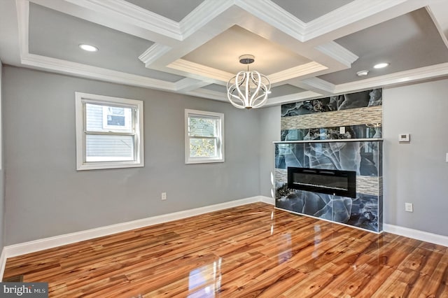 unfurnished living room featuring a fireplace, wood-type flooring, and ornamental molding