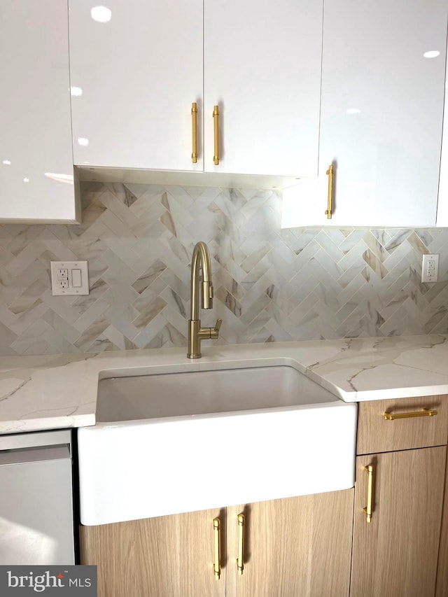 room details with light stone counters and decorative backsplash