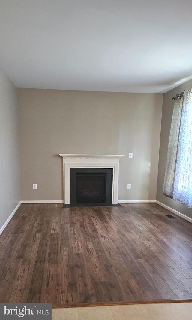 222 Dinwiddie Way, Kearneysville, WV 25430 - unfurnished living room with dark wood-type flooring, a fireplace, and baseboards