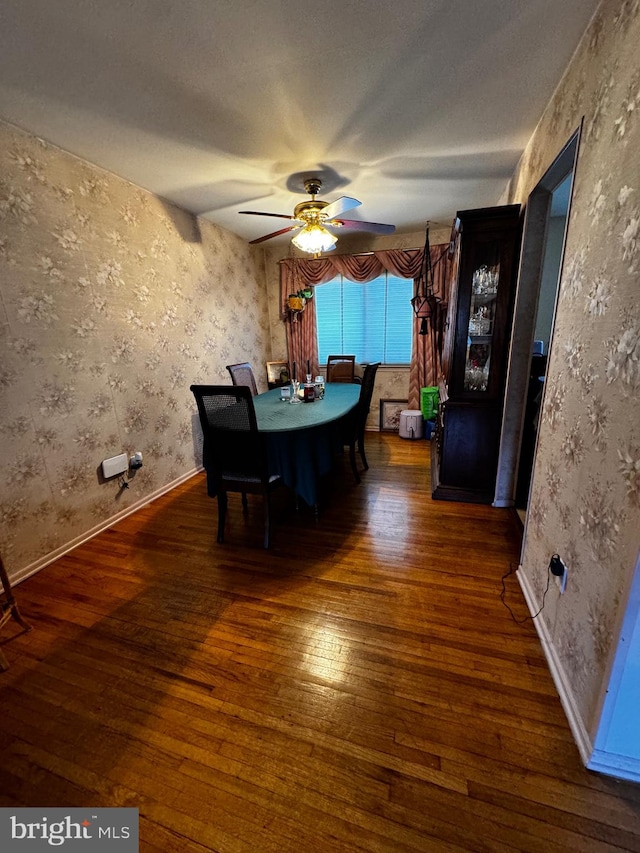 unfurnished dining area with ceiling fan and dark hardwood / wood-style flooring