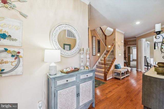 interior space featuring crown molding and hardwood / wood-style flooring