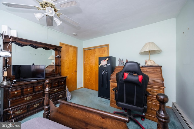 bedroom with a closet, baseboard heating, light colored carpet, and ceiling fan