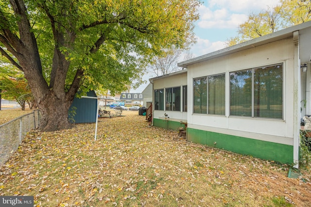 view of side of property featuring a sunroom