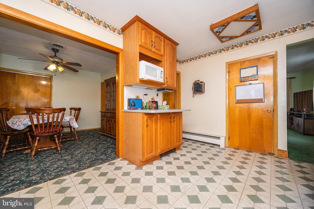 kitchen featuring a baseboard radiator and ceiling fan