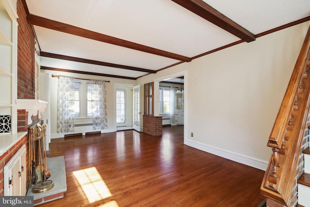 unfurnished living room with beamed ceiling and dark hardwood / wood-style floors