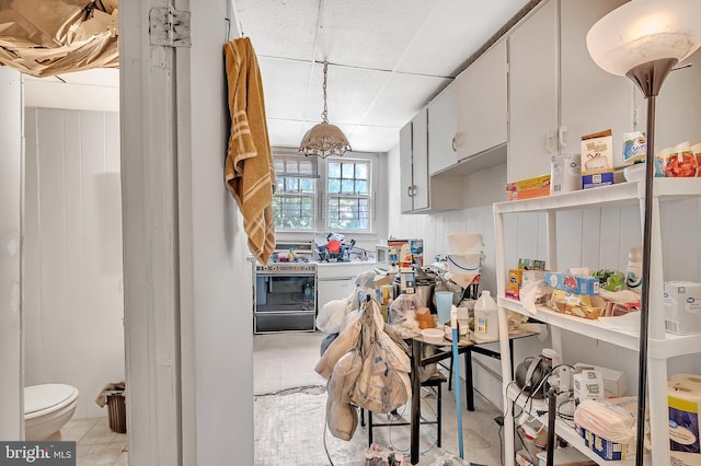 kitchen with hanging light fixtures and white cabinets