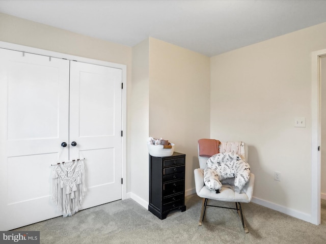 sitting room featuring light colored carpet