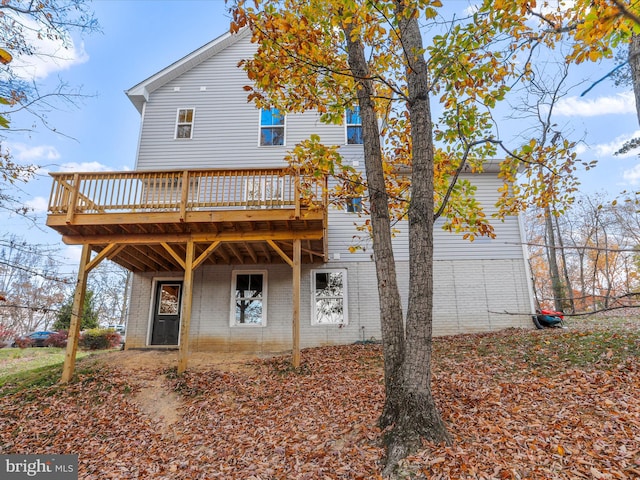 back of property with a wooden deck