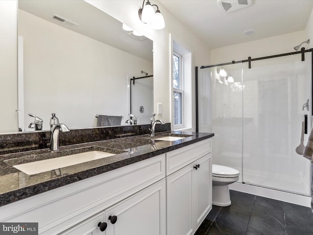 bathroom featuring vanity, toilet, a shower with shower door, and tile patterned flooring