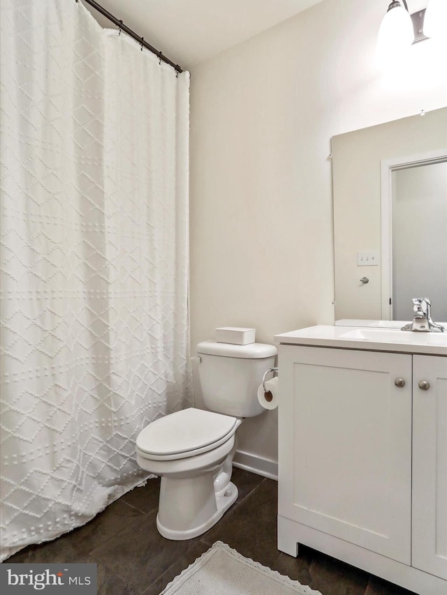 bathroom with vanity, curtained shower, toilet, and tile patterned floors