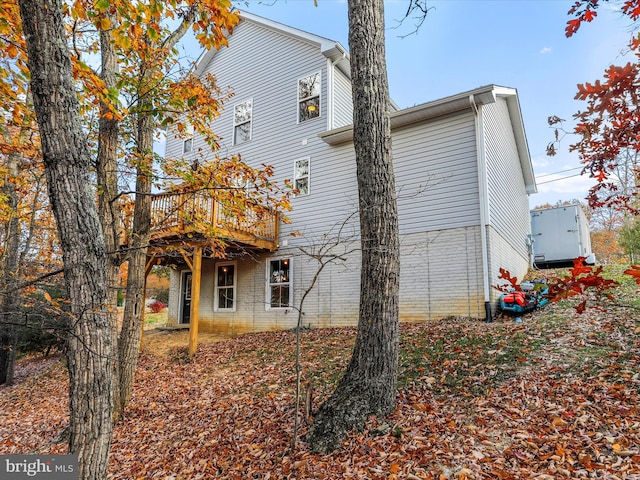 back of house featuring a wooden deck