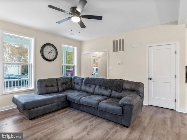 living room featuring ceiling fan, hardwood / wood-style flooring, and plenty of natural light