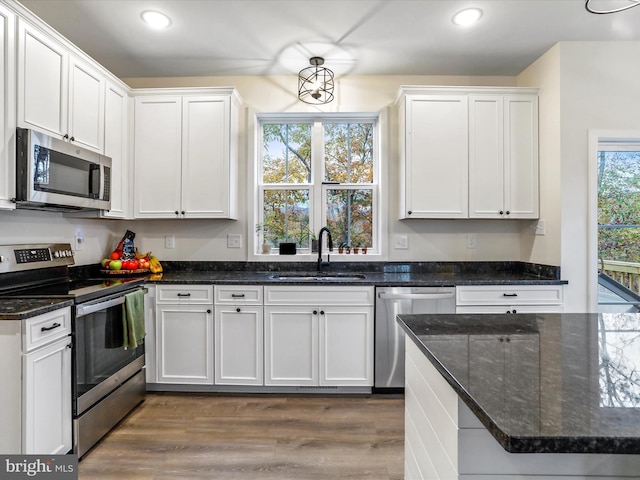 kitchen featuring sink, white cabinetry, and stainless steel appliances