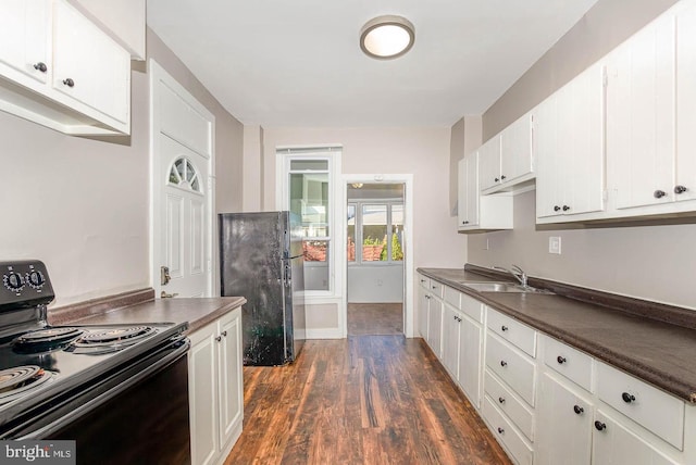 212 W Allen St, Mechanicsburg, PA 17055 - kitchen with a sink, dark countertops, white cabinetry, dark wood-type flooring, and black appliances
