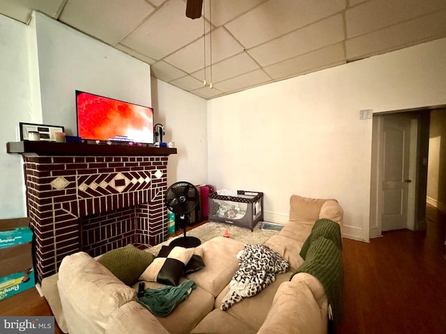 living room featuring ceiling fan and dark wood-type flooring