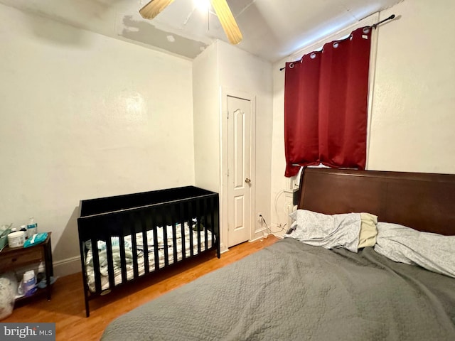 bedroom featuring hardwood / wood-style floors and ceiling fan