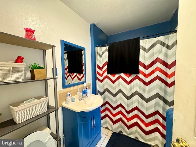 bathroom featuring a shower with curtain, tile patterned flooring, vanity, and toilet