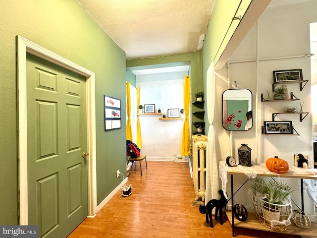 hallway featuring a textured ceiling and light wood-type flooring