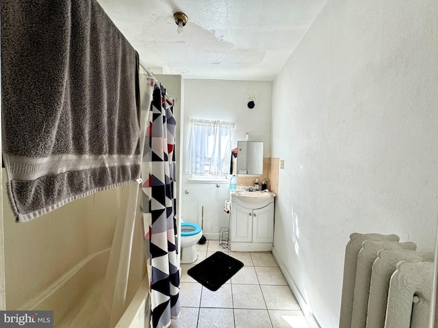 bathroom featuring tile patterned flooring, vanity, and toilet