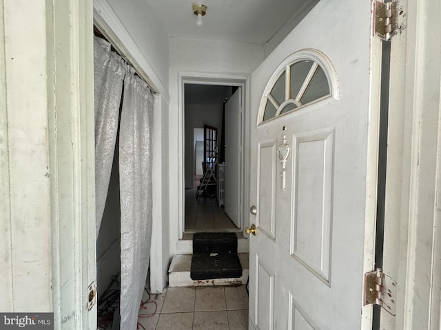 hall featuring light tile patterned floors