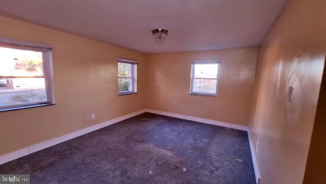 empty room featuring dark carpet