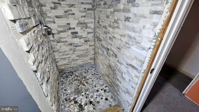 bathroom with tiled shower