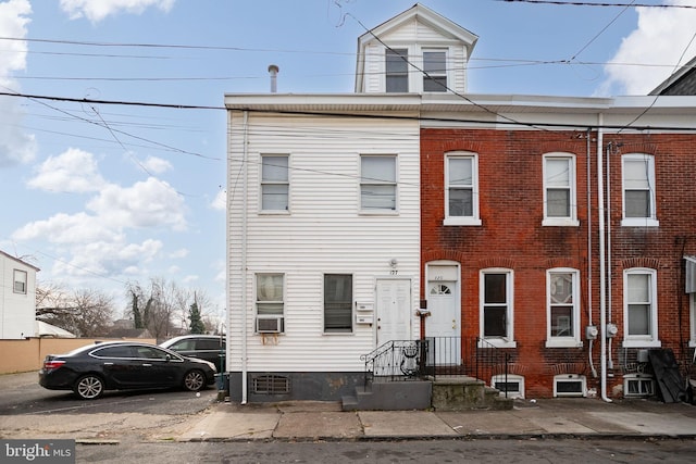 multi unit property featuring cooling unit and brick siding