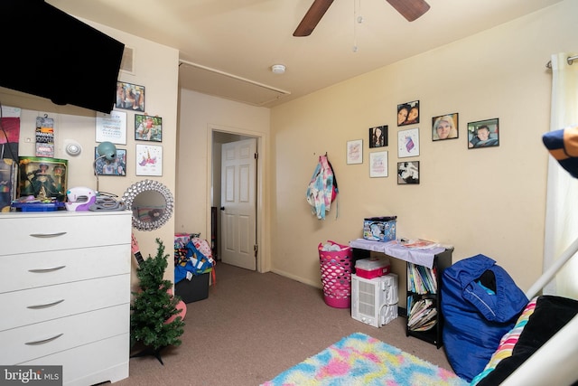 interior space featuring attic access, visible vents, carpet flooring, a ceiling fan, and baseboards
