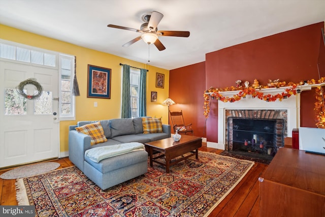 living room with a fireplace, hardwood / wood-style flooring, and ceiling fan