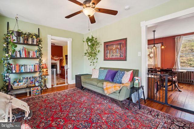 living room with hardwood / wood-style floors and ceiling fan