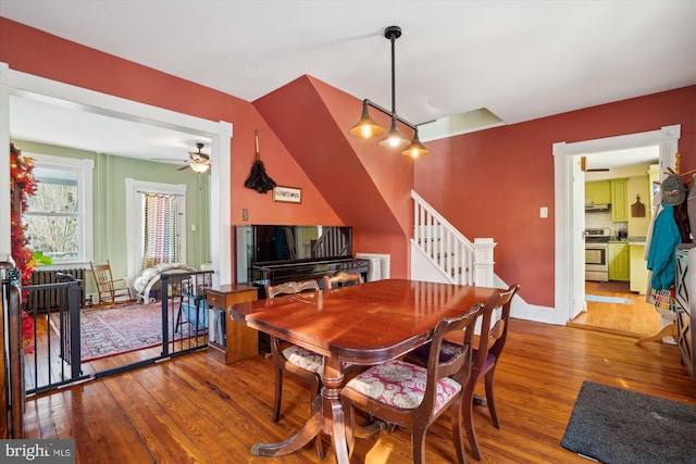 dining area with hardwood / wood-style flooring and ceiling fan