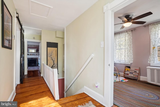 corridor featuring light hardwood / wood-style floors and radiator heating unit