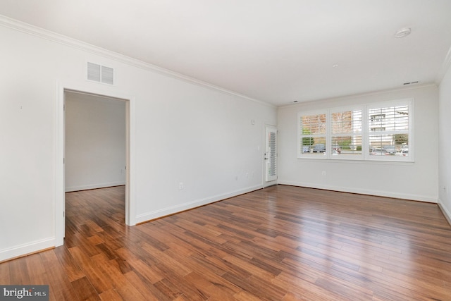 spare room with dark hardwood / wood-style flooring and ornamental molding