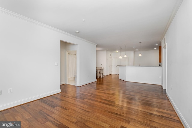 spare room featuring dark hardwood / wood-style flooring and ornamental molding