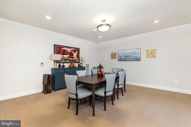 carpeted dining area with ornamental molding