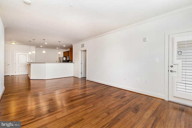 unfurnished living room with dark hardwood / wood-style flooring and crown molding