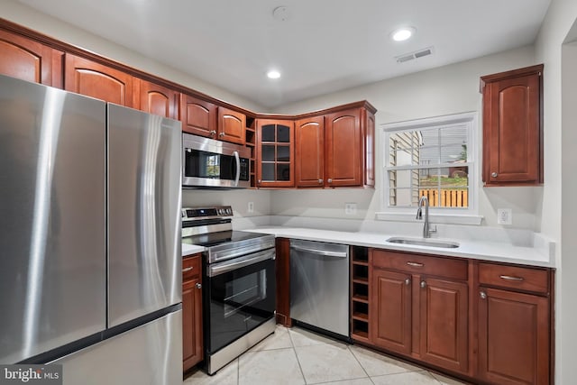 kitchen featuring sink, light tile patterned floors, and appliances with stainless steel finishes