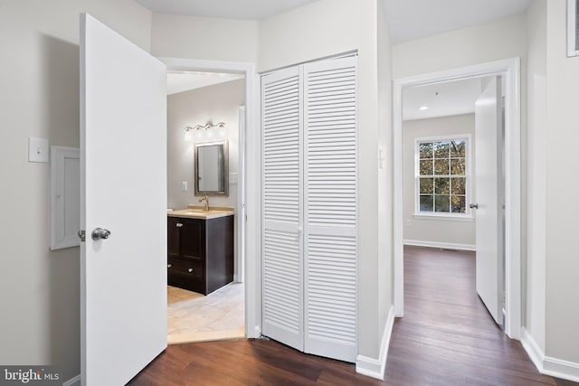 hallway with dark hardwood / wood-style flooring and sink