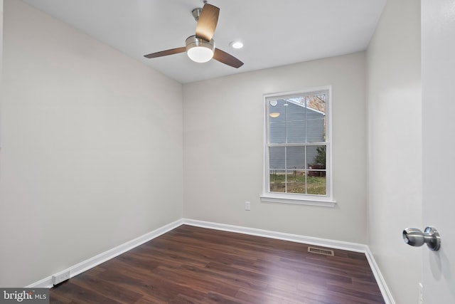 spare room with dark hardwood / wood-style floors and ceiling fan