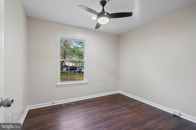 unfurnished room with ceiling fan and dark hardwood / wood-style flooring