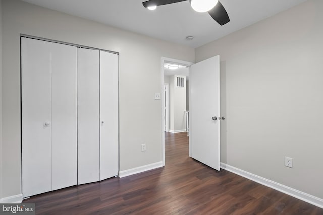 unfurnished bedroom featuring a closet, ceiling fan, and dark hardwood / wood-style flooring