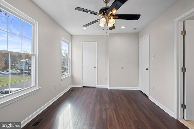 unfurnished bedroom featuring dark hardwood / wood-style flooring and ceiling fan