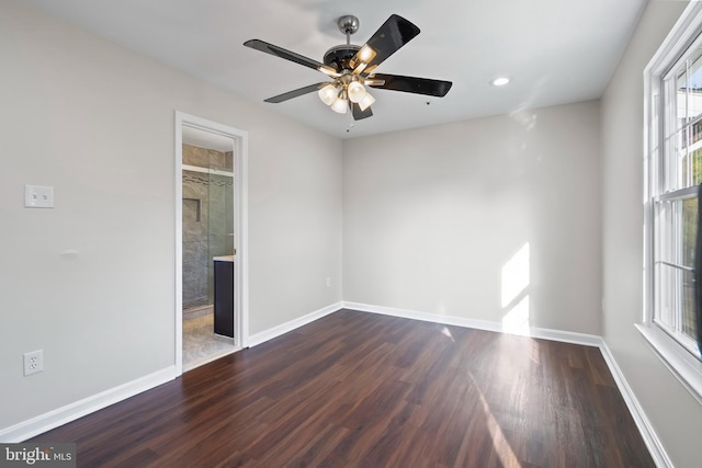 unfurnished room with ceiling fan and dark hardwood / wood-style flooring