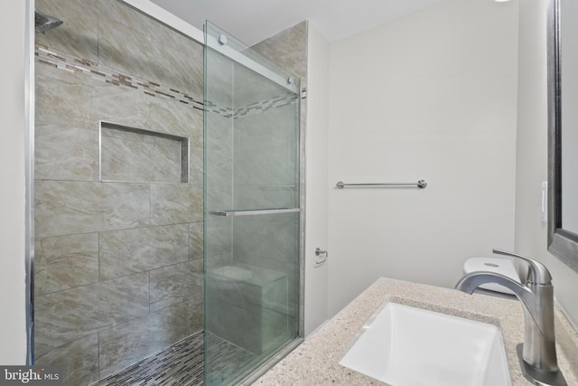 bathroom with vanity and a shower with shower door