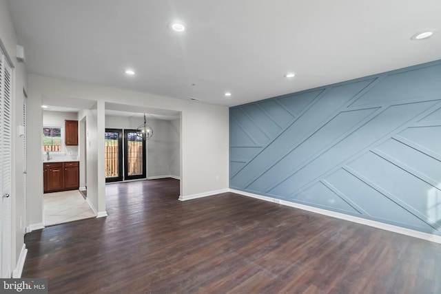 unfurnished living room with hardwood / wood-style floors and french doors