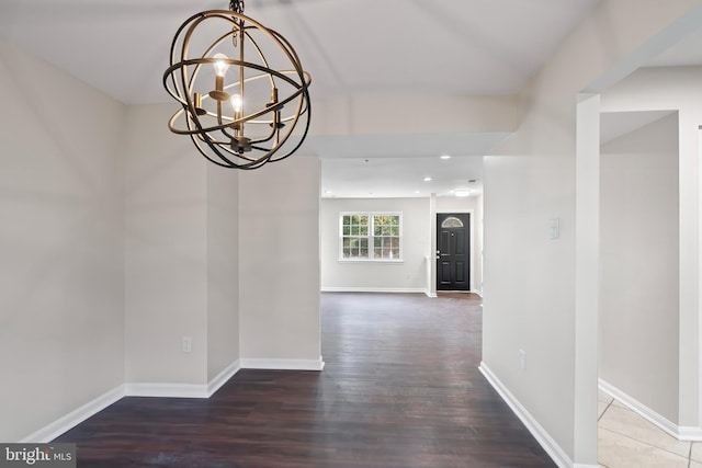 hall featuring dark hardwood / wood-style flooring and a notable chandelier